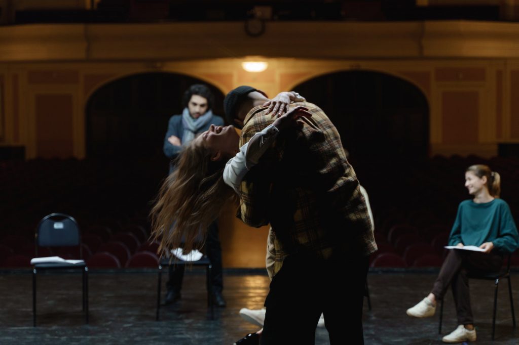 man hugging a woman on stage